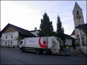 Kehrichtabfuhrwagen im Dorfkern