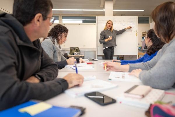Frau erklärt etwas in der Schule
