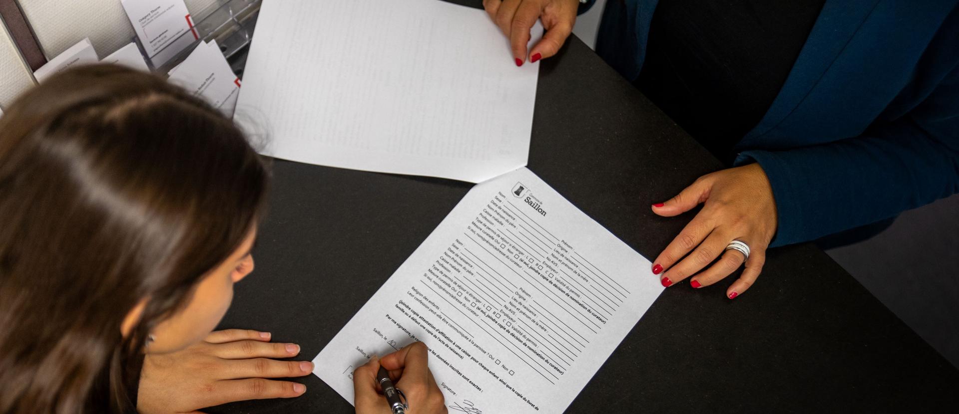 Citoyenne qui signe le formulaire de permis de séjour